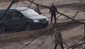 People in military uniforms near minibus beat man with their feet and struck him to ground. VIDEO