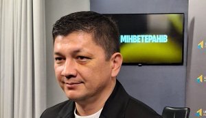 км