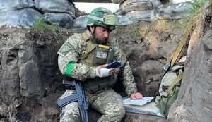 University Professor Sandor giving a lecture to students from a trench. PHOTO