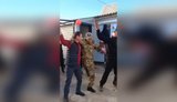 One-legged "hero of special military operation" in military uniform with letter "V" on his cap returned home and dances in yard with fellow villagers. VIDEO
