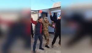 One-legged "hero of special military operation" in military uniform with letter "V" on his cap returned home and dances in yard with fellow villagers. VIDEO