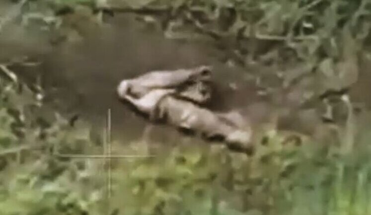 Russian soldier on battlefield shoots himself in head twice with automatic rifle. VIDEO