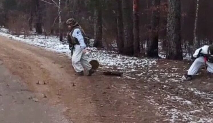 Russian pulling three anti-tank mines on rope and explodes on road. VIDEO