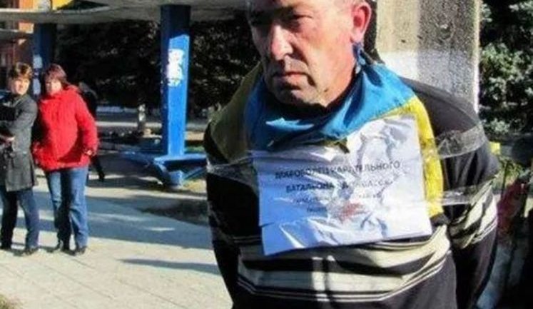 Terrorists Tied a Man with Ukrainian Flag to a Pole in Zuhres. PHOTO