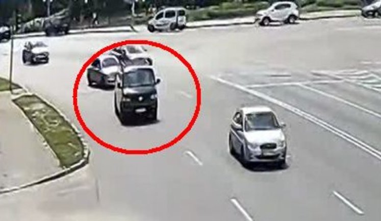 У Києві не поставлений на "ручник" мікроавтобус "втік" від водія заднім ходом, перетнув перехрестя і протаранив паркан. ВІДЕО камер спостереження