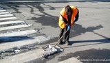 Women Wash Asphalt by Hand in Light of the Minister