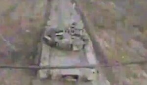 Ukrainian kamikaze drone flies into open hatch of enemy tank moving along road. VIDEO