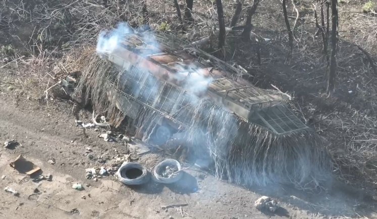 Russian tank equipped with "brush" and "barn" anti-drone protection systems burning on side of road. VIDEO