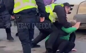 Odesa policeman beats woman