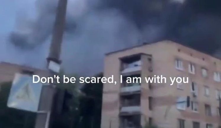Little boy on street in Vyshneve engulfed in smoke and flames, amidst sounds of explosions, reassures his mum: "Don’t be afraid. I’m with you. Don’t be afraid.". VIDEO