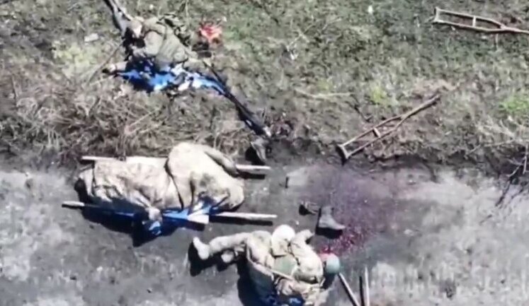 Eight eliminated occupiers, crutches and stretchers lie along road. VIDEO