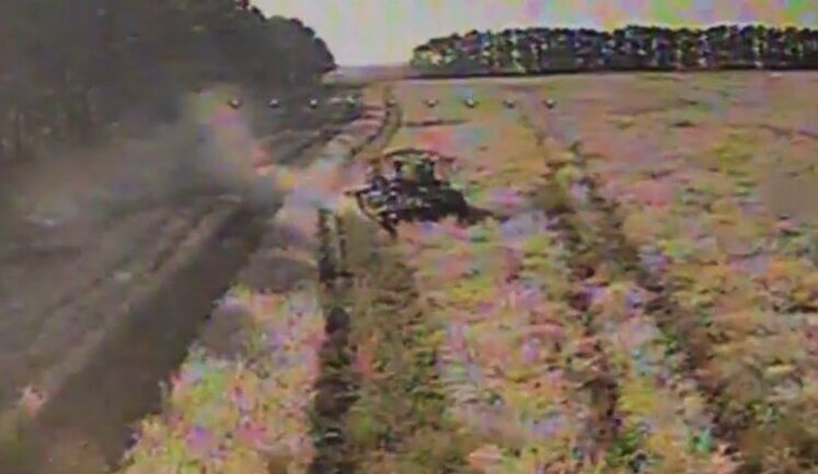 Russian armoured personnel carrier (APC) entering field with uncut grain explodes after Ukrainian drone attack. VIDEO