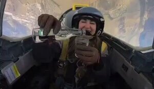 Russian female pilot pours vodka into glass while flying military plane. VIDEO