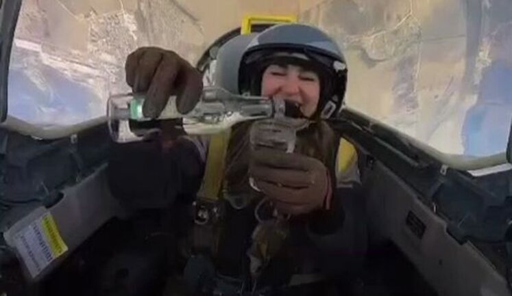 Russian female pilot pours vodka into glass while flying military plane. VIDEO