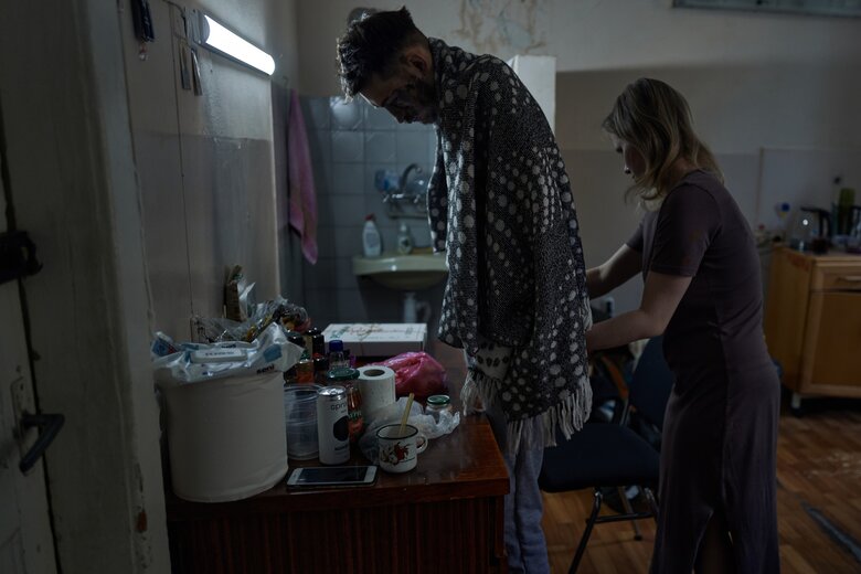 Wife in hospital hugs her husband, soldier of 47th brigade Andrii, who lost his hands and sight in battle against invaders 02