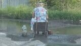 In Makiivka, people collect water from puddles
