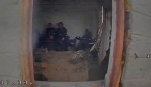 Дрон через вікно залітає у приміщення, у якому сидять четверо окупантів. ВIДЕО