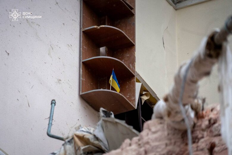 The flag of Ukraine on the ruins in Sumy