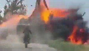 Russian motorised assault trooper watches as armoured vehicle with accomplices disappears in flames after hitting mine. VIDEO