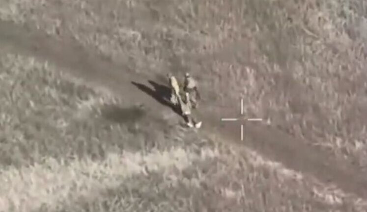 Two occupiers drag their "three hundredth" and then leave him to die on road. VIDEO
