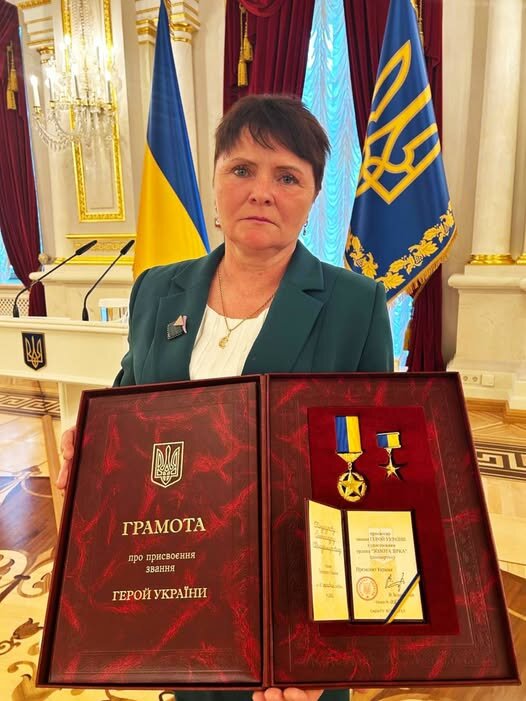 Alexander Kandaur's mother with his awards