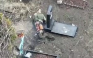 burnt Russian crawling through cemetery