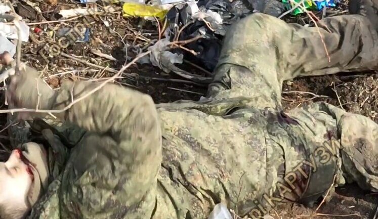 Russian invader kicks bucket in field woodland littered with garbage after precise munition drop. VIDEO