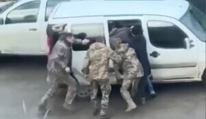 Three men in military uniforms and three in civilian clothes beat man and take him away in unknown direction in Lviv. VIDEO