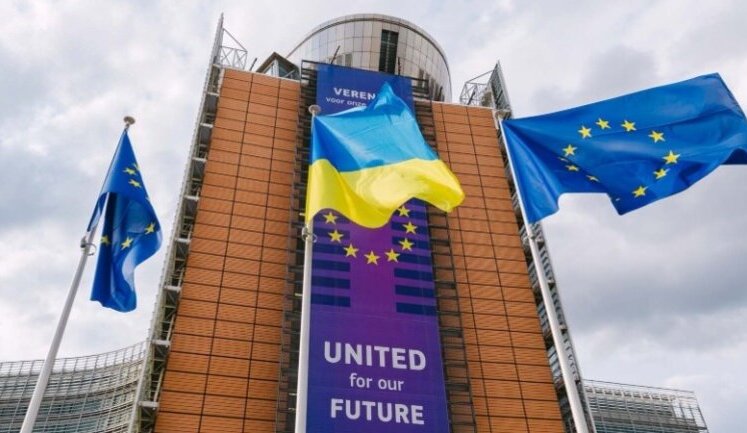 "We are with you": Ukrainian flag flies in front of European Commission headquarters in Brussels. PHOTO