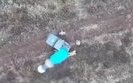 дрон сбрасывает боеприпас на российских штурмовиков