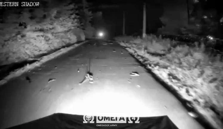 Local resident clears road and helps "Omega" fighters’ ground robot continue moving. VIDEO