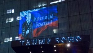 "Happy to help, bro": Putin's image and Russian flag projected on Trump hotel in New York. PHOTOS
