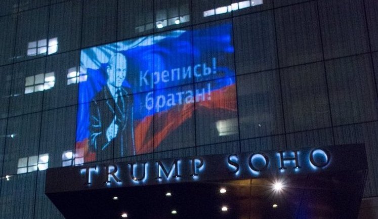 "Happy to help, bro": Putin's image and Russian flag projected on Trump hotel in New York. PHOTOS
