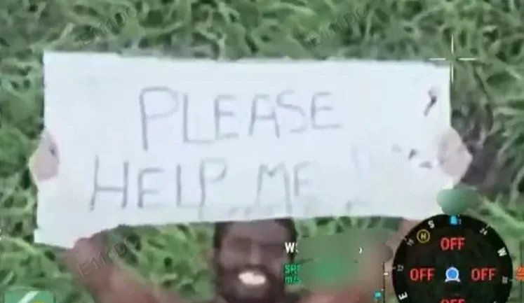 African mercenary in Russian army walks naked across battlefield with "Please help me" sign.. VIDEO